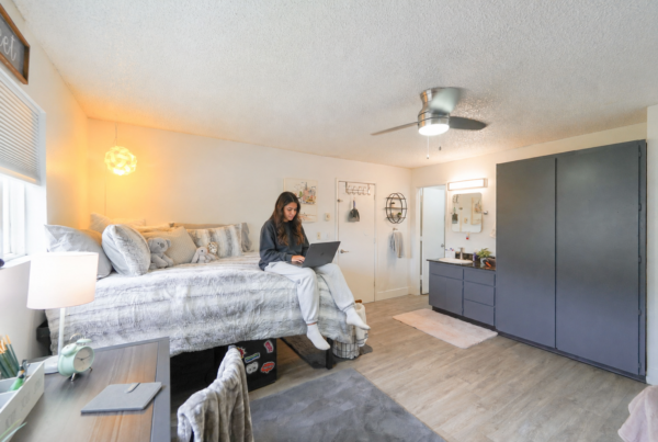 Student relaxing in a furnished apartment at Capri Eugene